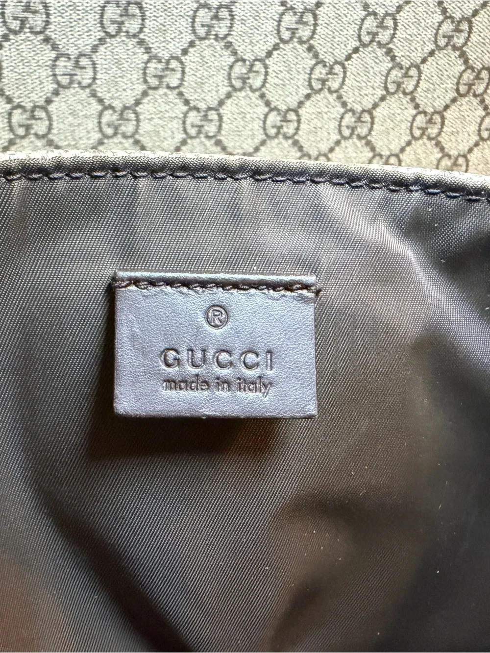 GG Supreme canvas diaper bag, designed with multiple pockets and fold-out pad